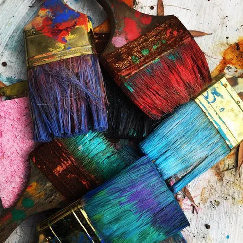 Paint brushes covered in colour